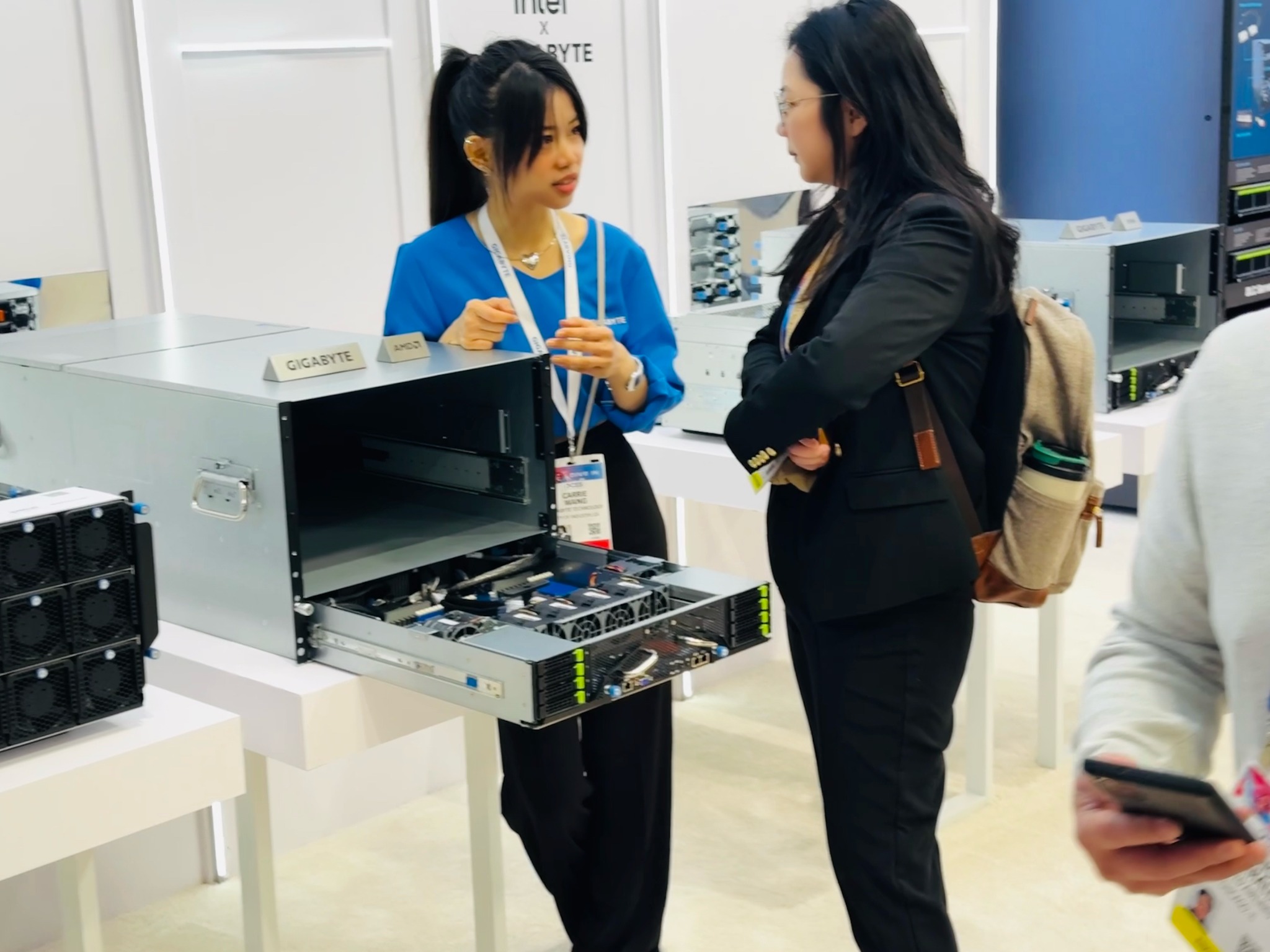 Carrie Wang speaking with a customer at an enterprise technology booth